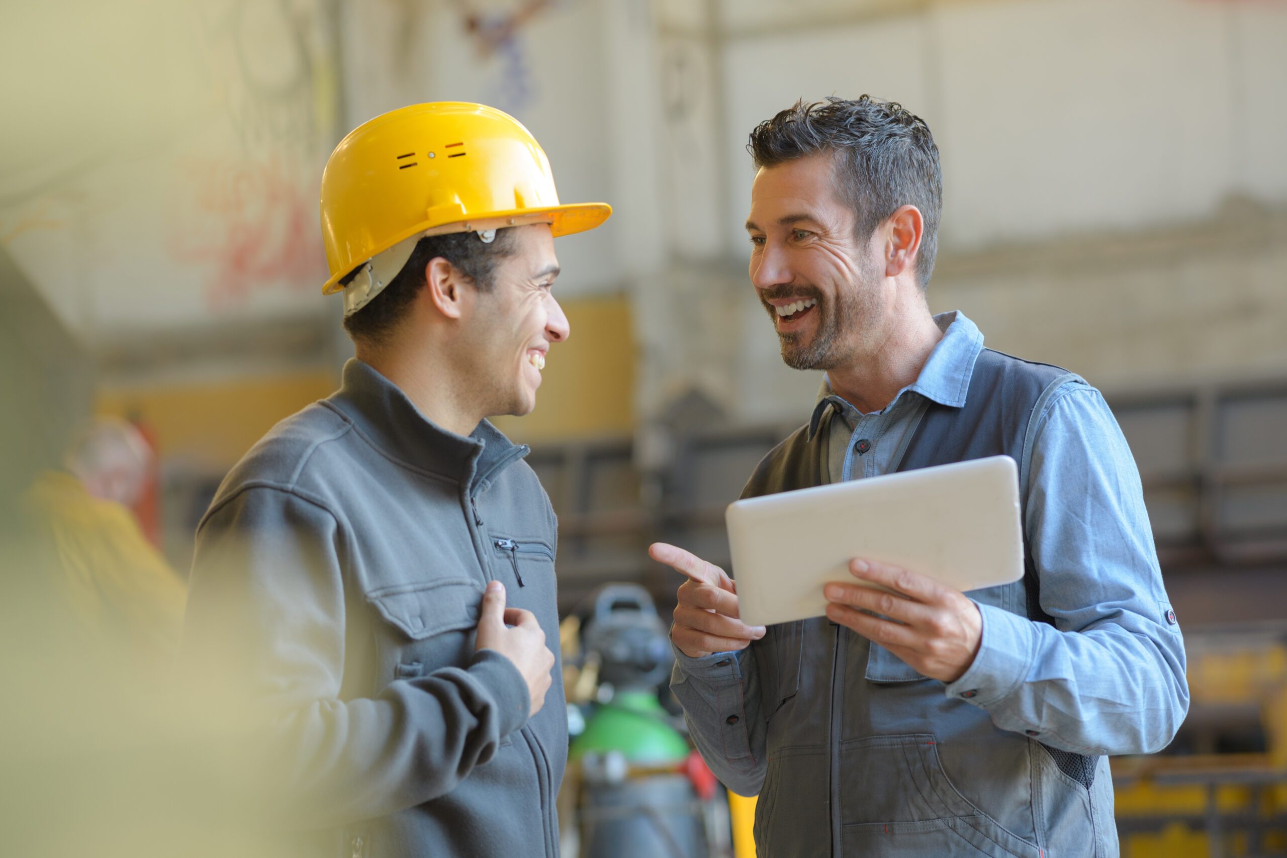 workers talking and laughing at a factory 