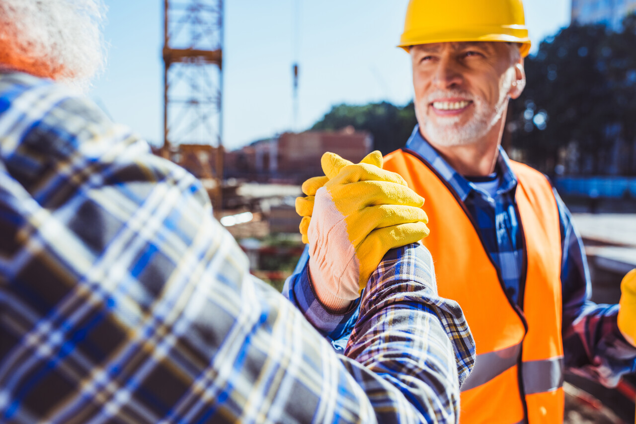 construction workers shaking hands